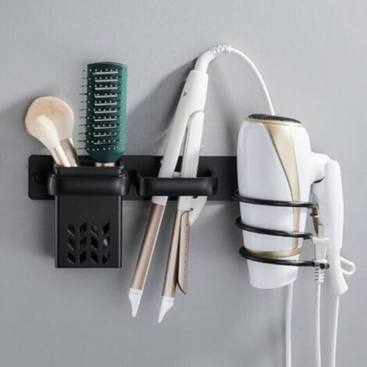 Black wall-mounted hairdryer holder with cable organizer and storage shelf, for bathroom, bedroom, hotel